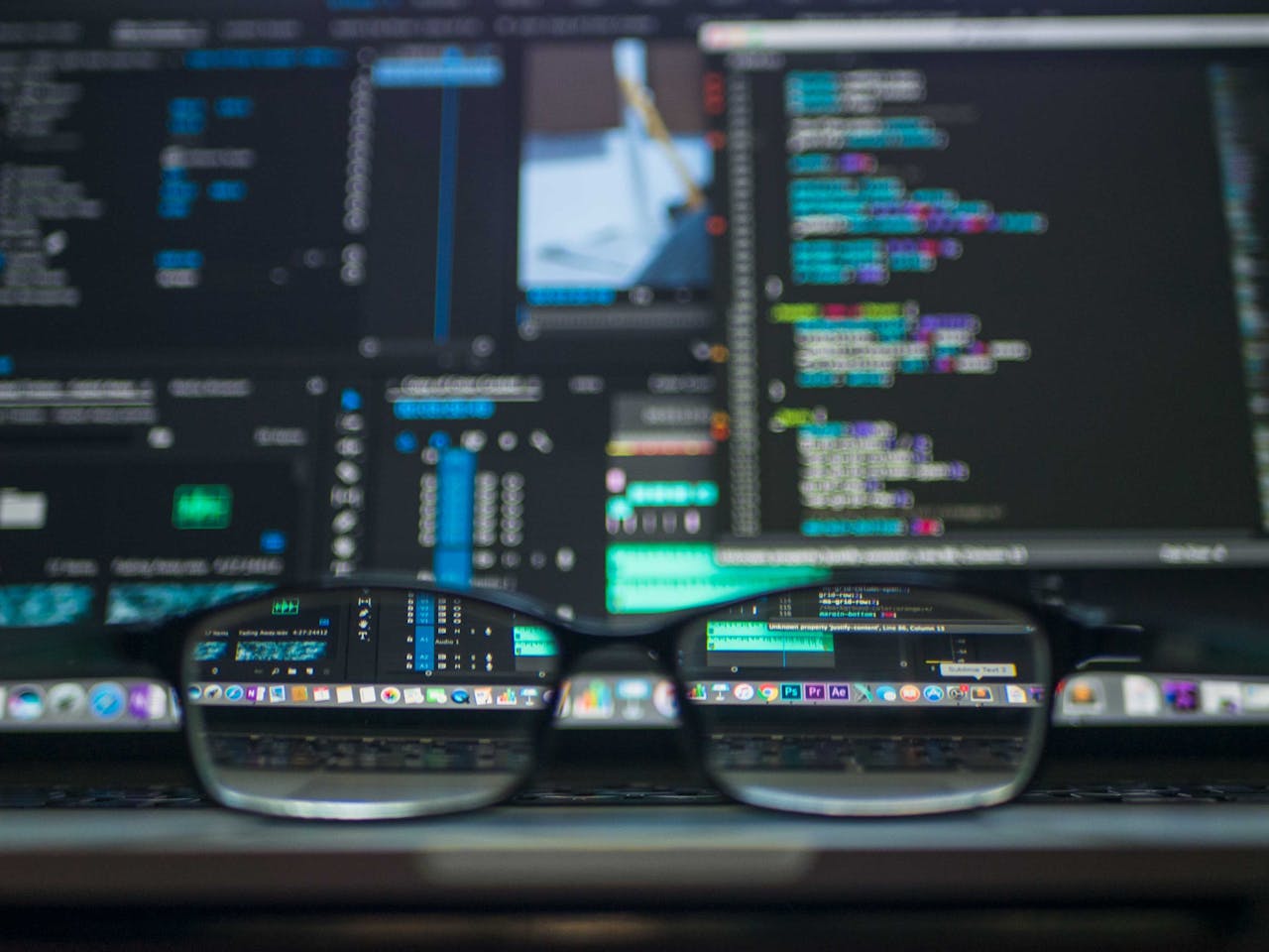 services-04 Eyeglasses reflecting computer code on a monitor, ideal for technology and programming themes.